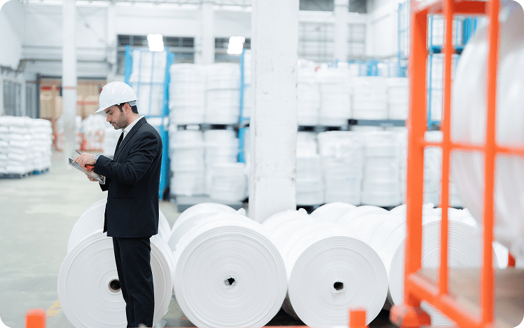 Worker inspecting materials in warehouse